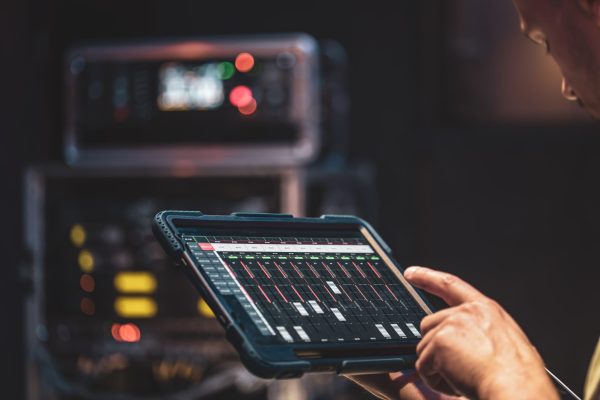 Remote control and sound setting from the tablet, the sound engineer adjusts the sound, copy space.