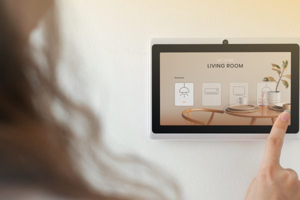 Smart home innovation technology with woman using control panel