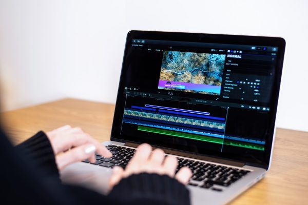 Young content creator girl editing video on her laptop. Working from home